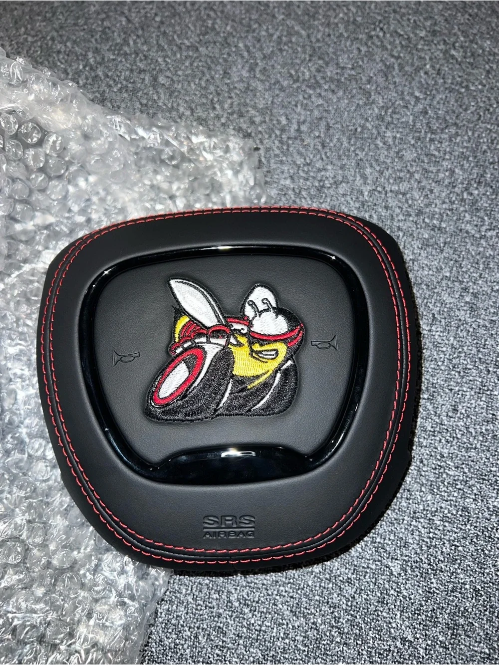 Black Airbag Cover with Red Stitching and Bee Patch